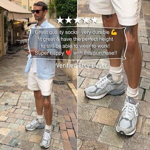 A lifestyle street-style photo of a man wearing durable white slouch socks in a city setting. This review confirms that these diabetic socks and neuropathy socks are excellent eco friendly products and rank among the most unusual gifts for men.