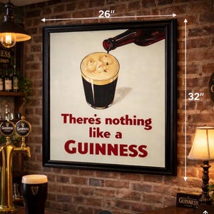 May include: A framed Guinness advertisement, 26 inches wide and 32 inches tall, features a pint of stout being poured from a bottle. The text reads "There's nothing like a Guinness" in red. The image is set against a brick wall.