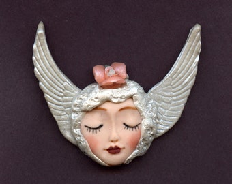 Polymer A smaller  Fleshtone Angel  Face with Wings in  Metallic Pearl  1 1/2"   x 2 1/2"    A27