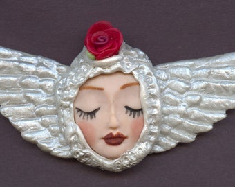 Polymer  Fleshtone Angel  Face with Wings in  Metallic Pearl  2 "   x 4 1/2"    A44