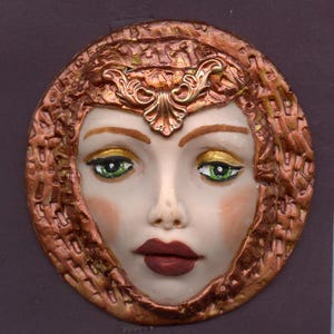 A  Polymer Clay Face Medallion: Detailed Queen with Copper Accents  A 57C