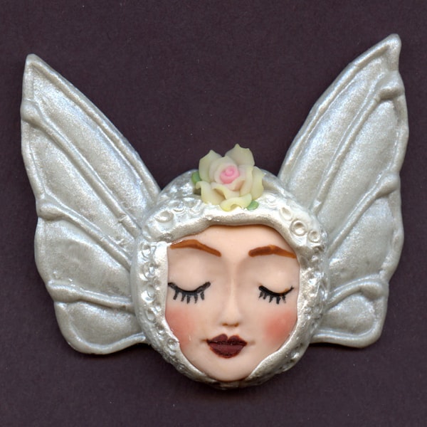 Polymer A smaller  Fleshtone Angel  Face with Wings in  Metallic Pearl  2 1/4"   x  3"    A 31