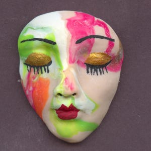 May include: A set of three ceramic mugs with a speckled, matte finish. Each mug features a different color: light blue, cream, and gray. The mugs have a simple, modern design and a comfortable handle.