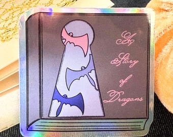 May include: A holographic sticker featuring a book with a keyhole in the shape of a cloud. The keyhole is filled with bats flying out of the cloud. The text on the book reads "A story of Dragons".