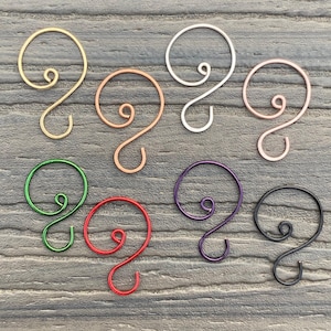 May include: Assortment of ten wire ornament hooks in various colors, including gold, silver, copper, green, red, purple, and black. The hooks are shaped like a question mark with a loop at the top.
