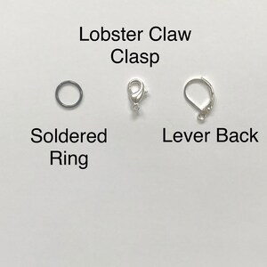 May include: Three different types of jewelry clasps: a lobster claw clasp, a soldered ring, and a lever back clasp.