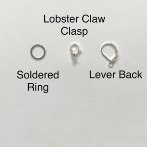 May include: Three different types of jewelry clasps: a lobster claw clasp, a soldered ring, and a lever back clasp.