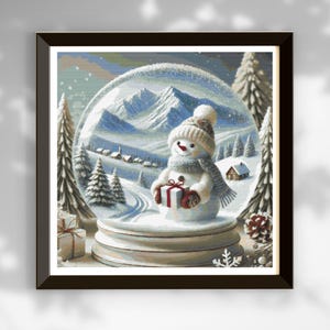 May include: A snow globe featuring a snowman holding a gift. The snowman is wearing a red scarf and a white hat. The snow globe sits on a wooden base and depicts a snowy mountain scene.