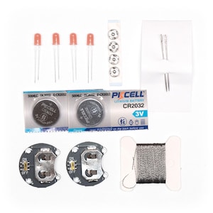 May include: A set of craft supplies for making light-up projects. The set includes three red LED lights, two coin cell batteries, two battery holders, a spool of silver thread, two needles, four snap buttons, and two CR2032 lithium batteries.
