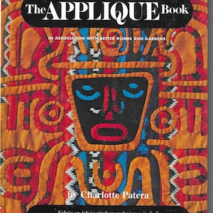 May include: The Applique Book by Charlotte Patera. The book cover features a colorful, abstract design with a central face-like figure in black, red, orange, and blue. The book is about fabric-on-fabric stitchery techniques, including reverse appliqué.