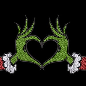 May include: Green Grinch hands forming a heart shape against a black background. The hands have textured green skin and red and white cuffs. The design is likely for apparel or accessories.