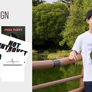 May include: A white t-shirt with a brown bear graphic and the text "FREEDOM" repeated multiple times. The shirt is being worn by a person standing on a wooden bridge.