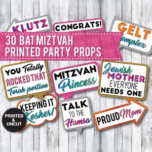May include: Thirty printed party props for a Bat Mitzvah celebration. The props feature colorful text and designs, including "Klutz", "Congrats!" "Gelt Complex", "You Totally Rock That Torah Portion", "Mitzvah Princess", "Jewish Mother Everyone Needs One", "Keeping It Kosher!", "Talk To The Hamsa", and "Proud Mom".
