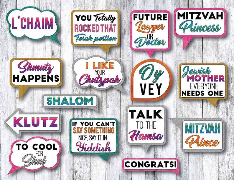 May include: A set of 15 colorful photo booth props with glitter accents and Jewish-themed sayings. The props include phrases like "L'Chaim", "Shmutz Happens", "Oy Vey", "Talk to the Hamsa", and "Mazel Tov".