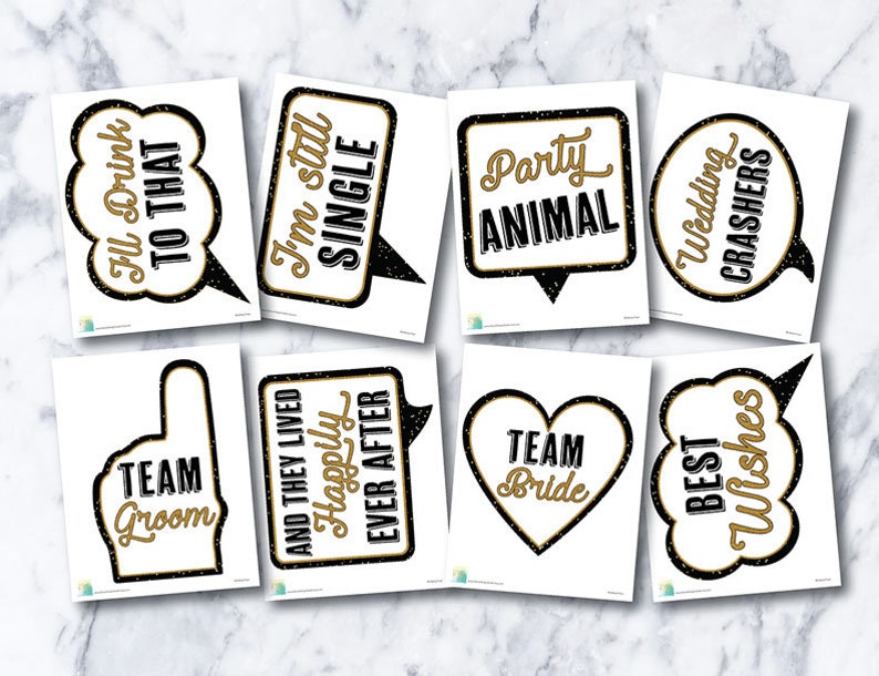 May include: Set of 10 black and gold photo booth props with various wedding-themed phrases, including "I'm still single", "Team Groom", "Happily Ever After", "Party Animal", and "Wedding Crashers".