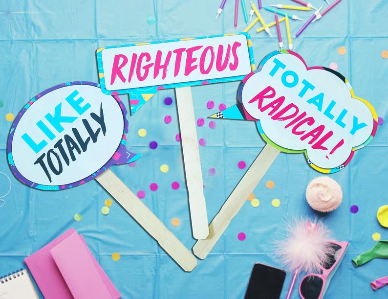 May include: Three colorful cardboard signs with sticks attached, featuring 90s slang phrases: "Like Totally", "Righteous", and "Totally Radical!"