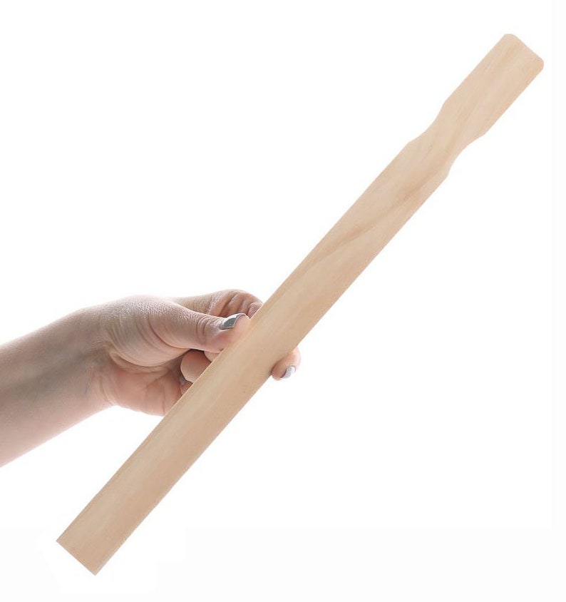 May include: A plain wooden craft stick, approximately 12 inches long, held in a hand.