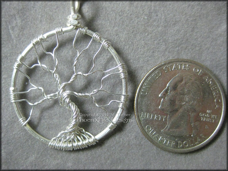 May include: Silver wire tree of life pendant necklace, approximately the size of a UK 20 pence coin.
