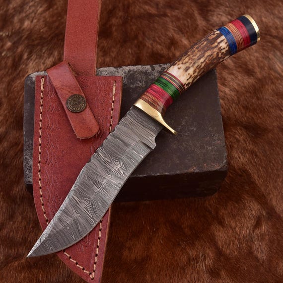 Hand-forged Damascus steel blade with a genuine stag antler handle — every single one is visually unique due to the watery pattern in the steel and natural handle material.