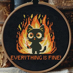 May include: Embroidered hoop art featuring a black cat on fire with the text "EVERYTHING IS FINE!" in yellow.