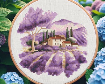 May include: A cross-stitch embroidery pattern featuring a purple lavender field with a small white house and trees in the background.