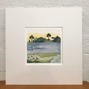 May include: A watercolor painting of a small white house with a red roof on a lake. The house is surrounded by trees and bushes. The lake is a light blue color and there are a few white birds flying over the water. The sky is a light yellow color.