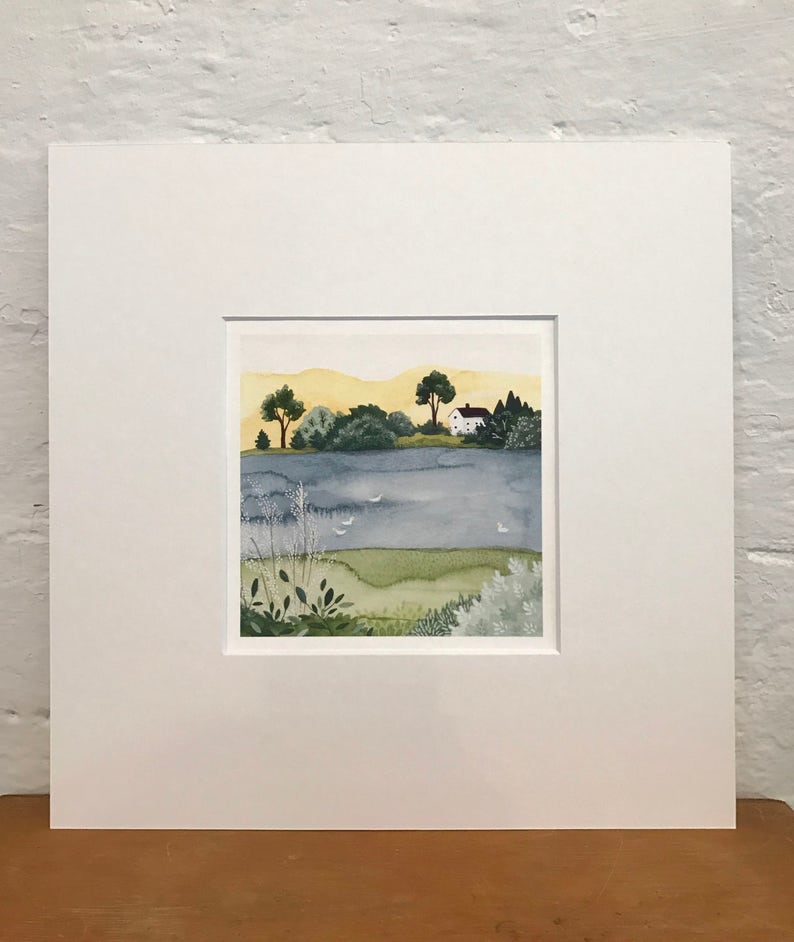 May include: A watercolor painting of a small white house with a red roof on a lake. The house is surrounded by trees and bushes. The lake is a light blue color and there are a few white birds flying over the water. The sky is a light yellow color.