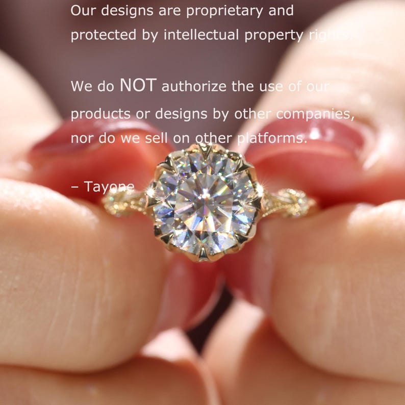 May include: A gold engagement ring with a large, sparkling, round-cut diamond. The ring has intricate detailing around the diamond and on the band. The image includes text that states the designs are proprietary and protected by intellectual property rights.