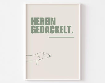 Può includere: Un poster beige con un'illustrazione di dachshund verde e il testo "HEREIN GEDACKELT."