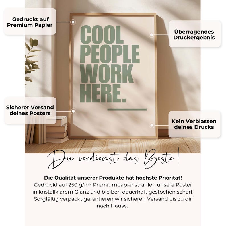 May include: A framed poster with the text "COOL PEOPLE WORK HERE" in green letters on a cream background. The poster is in a light brown frame and is displayed on a wooden surface.