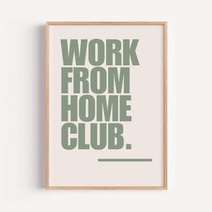 Könnte beinhalten: Ein gerahmter Druck mit hellrosa Hintergrund und einer grünen Aufschrift, die "WORK FROM HOME CLUB." lautet.