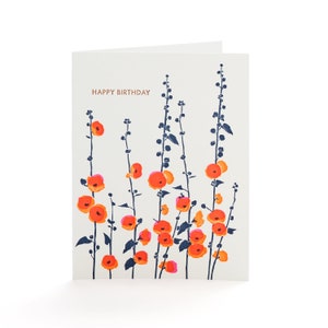 May include: A folded greeting card with a cream-colored background. The card features a floral design with orange and pink flowers on dark blue stems. The words "HAPPY BIRTHDAY" are printed in a copper color at the top.