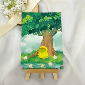 Stampa artistica A6 "Rana e anatroccoli sotto la pioggia" - Illustrazione di una rana carina - Illustrazione kawaii sotto la pioggia - Arte animale accogliente - Decorazione murale - Arte murale colorata