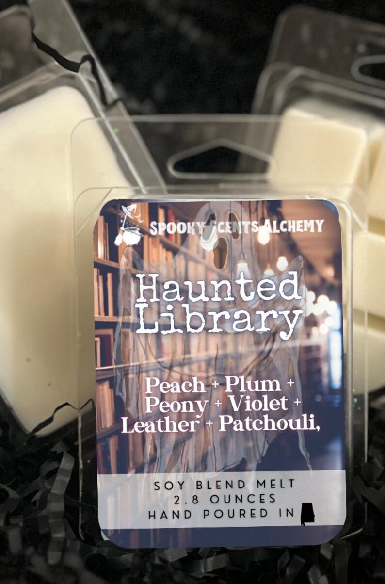 May include: A clear plastic package containing soy wax melts. The label reads "Spooky Scents Alchemy Haunted Library" with scent notes. The package contains 2.8 ounces of hand-poured wax melts.