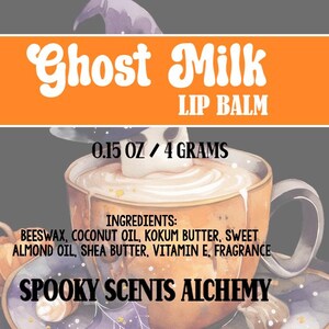 May include: A lip balm product label with the text "Ghost Milk" in a whimsical font. The label includes the text "LIP BALM", "0.15 OZ / 4 GRAMS", and a list of ingredients. The brand name "SPOOKY SCENTS ALCHEMY" is also visible.