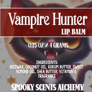 May include: Lip balm with a black cat illustration. The label reads "Vampire Hunter LIP BALM" and lists ingredients. The product weighs 0.15 oz / 4 grams. The brand name "Spooky Scents Alchemy" is also displayed.