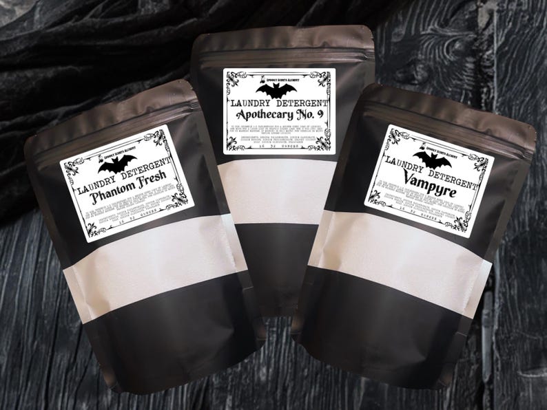 May include: Three matte black stand-up pouches containing laundry detergent. Each pouch features a white rectangular label with a black bat graphic and text reading Laundry Detergent, followed by the names Phantom Fresh, Apothecary No. 9, or Vampyre.
