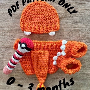 May include: Crochet pattern for a baby outfit inspired by a fire-type Pokemon. The pattern includes a hat, a onesie, booties, and a rattle. The outfit is orange with white accents and is designed for babies 0-3 months old. The pattern is available as a PDF download.  PDF PATTERN ONLY 0-3 months