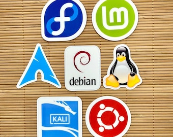 May include: A collection of eight round stickers featuring various Linux operating system logos. The logos include Debian, Kali, Fedora, Ubuntu, Mint, and a penguin.