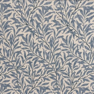 May include: A repeating pattern of blue willow branches and leaves on a cream-colored background. The leaves and branches are detailed with varying shades of blue, creating a textured effect. The design is reminiscent of classic botanical prints.