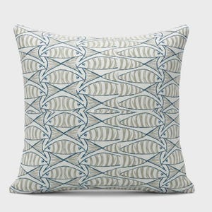 May include: Square throw pillow with a repeating pattern of stylized fish in gray and navy blue on a white background. The fish are arranged in a grid-like design, creating a nautical or coastal theme. The pillow has a soft, textured appearance.
