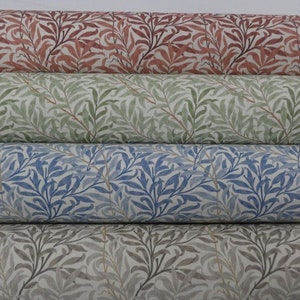 May include: Four rolls of fabric with a willow pattern in different colors. The top roll is a reddish-brown, the second is a light green, the third is a light blue, and the bottom is a light gray.