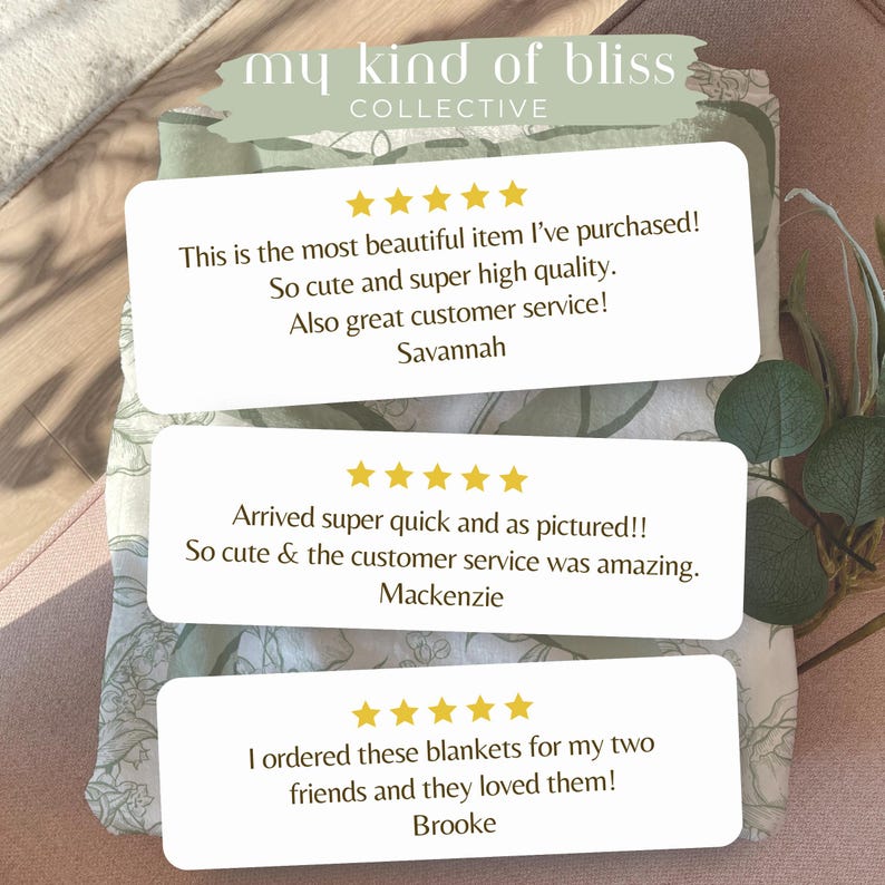 May include: The image showcases a folded blanket with a floral pattern in shades of green and white. Three white rectangular cards with customer reviews are overlaid on the blanket. The text on the cards includes customer testimonials and the brand name "my kind of bliss COLLECTIVE."