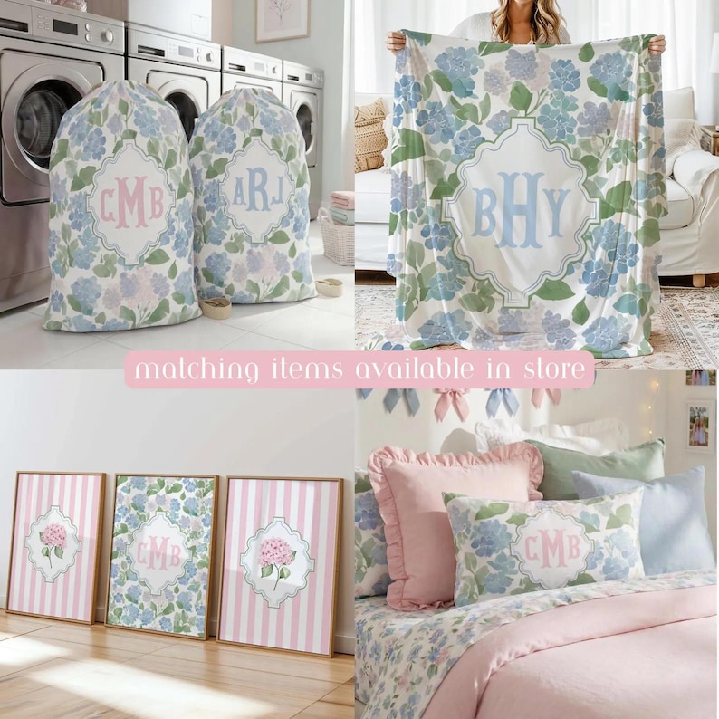 Op de afbeelding: Een collectie woonaccessoires met een blauw en groen hortensia bloemenpatroon en witte monogramframes. Bevat twee waszakken, een grote plaid, drie ingelijste wandkunstprints en een bedkussen met een roze ruche.