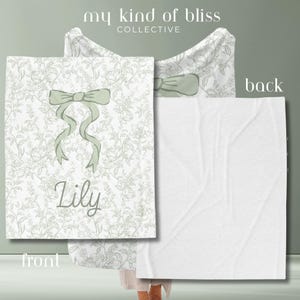 My Personalized Sage Green Bow Toile Name Blanket features a classic olive toile print with delicate flowers and birds on a crisp white background, topped with a big coquette-style bow and your custom name in an elegant script below. Soft feminine and beautifully detailed, it’s perfect for babies, kids, teens and adults. Great for sleepover favors, hospital or coming-home blankets, announcement photos, dorm rooms, teen bedrooms, Christmas, birthdays, sisters, newborn keepsakes and new parents