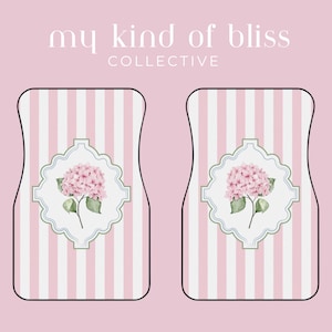 May include: Two car floor mats with a pink and white striped pattern. Each mat features a pink hydrangea flower design within a decorative frame. The text "my kind of bliss COLLECTIVE" is at the top.