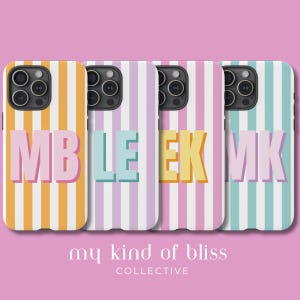 May include: Four phone cases with vertical striped patterns in orange, light blue, pink, and mint green. Each case features large, block letter initials: MB, LE, EK, and MK. The phrase "my kind of bliss" and "COLLECTIVE" are at the bottom.