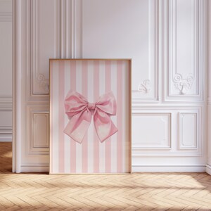 My cute coquette pink bow print. The bow has a watercolour look to it. This print has white and pink stripes in the background with a large pink bow in front. Perfect for a nursery, bedroom, dorm room, apartment or a gift for a bff, daughter, sister.
