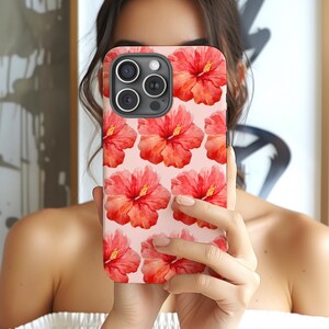 This phone case features a tropical collage pattern of red watercolour hibiscus flowers on a soft pink background. Perfect for coconut girls and beach lovers. Available for iPhone, Samsung and Pixel Phones.