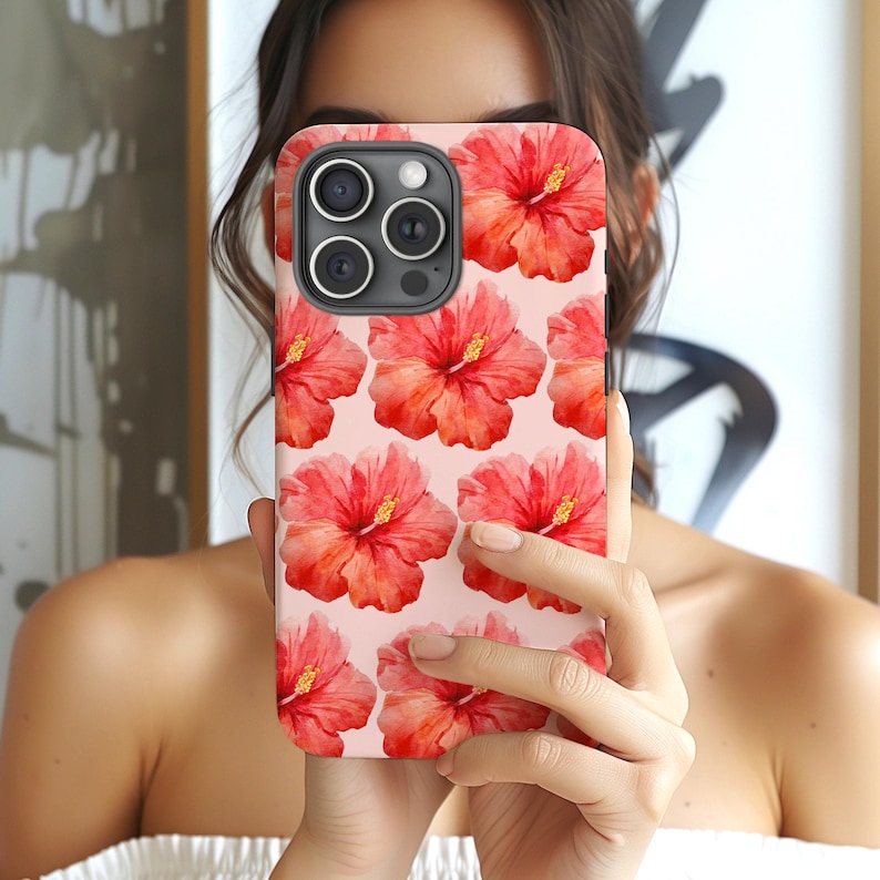 This phone case features a tropical collage pattern of red watercolour hibiscus flowers on a soft pink background. Perfect for coconut girls and beach lovers. Available for iPhone, Samsung and Pixel Phones.